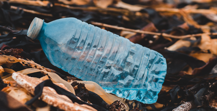 En esta imagen vemos una botella plástica de color azul sobre la tierra. La imagen quiere representar que el plástico demora mucho tiempo en degradarse, y cuando lo haga, se transformará en micropartículas que contaminarán el medio ambiente.